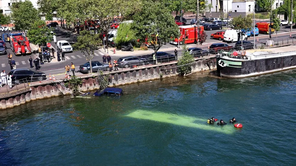 Picture of a bus crashed into a river.