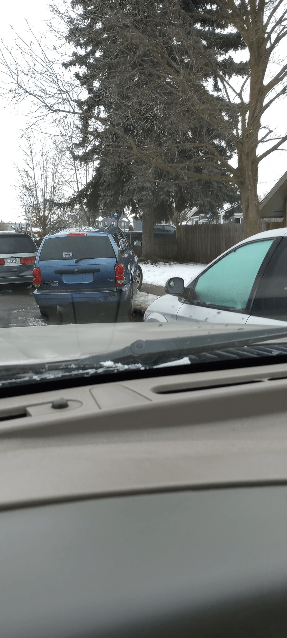 suv without plates parked cockeyed on the sidewalk 