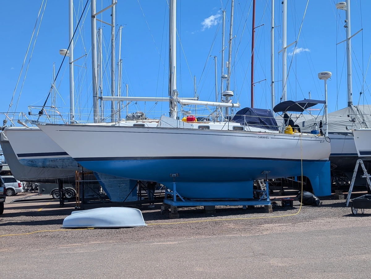 A sailboat on a stand with fresh blue bottom paint.