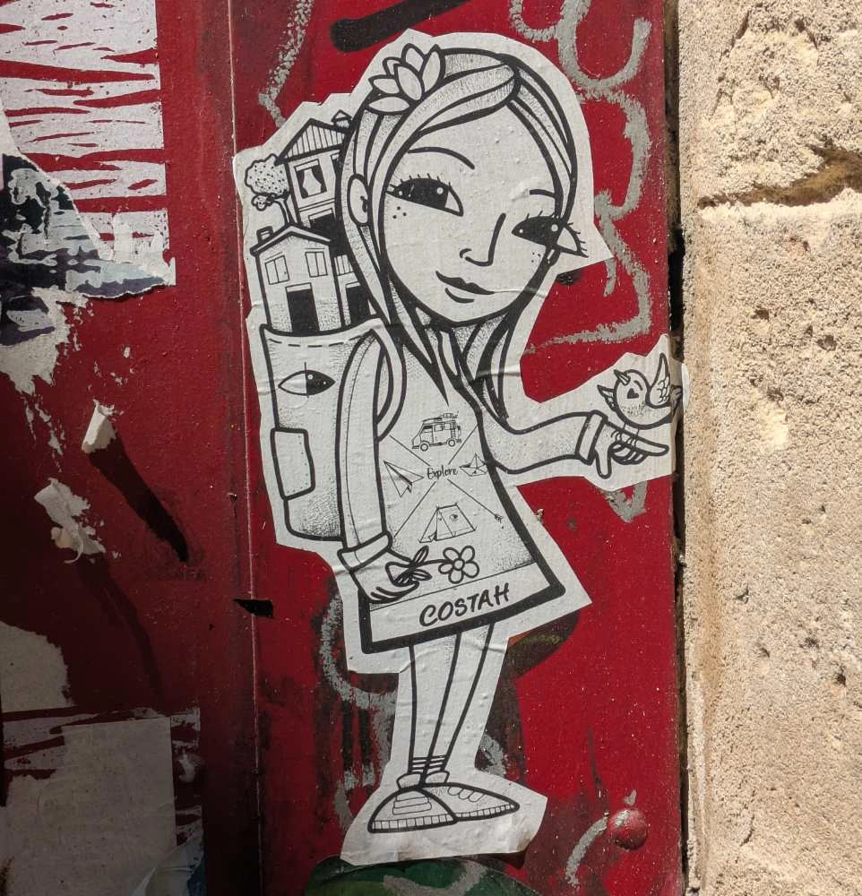 wheatpaste of a girl withhousee in her back pack and a bird sitting on her raised finger. white paper, black lines on red gate