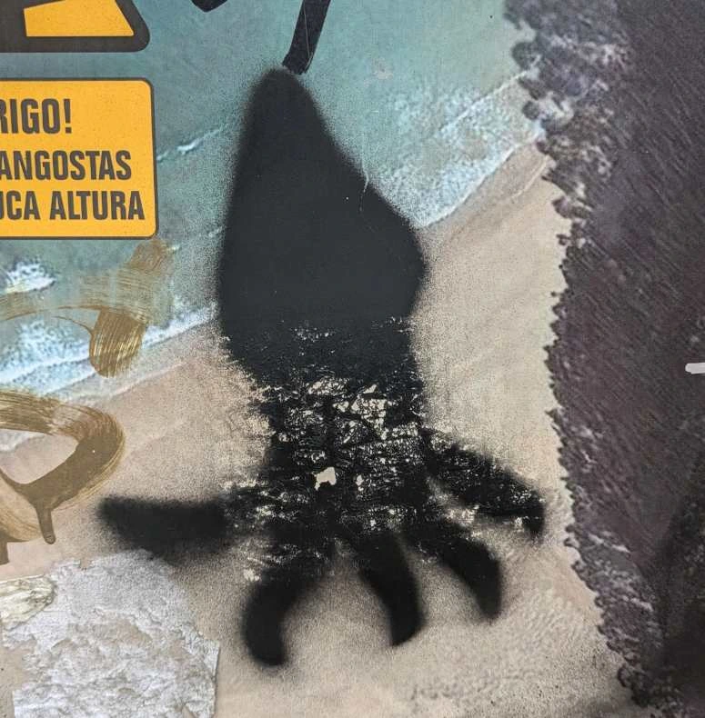 black squid stenciled with spray paint on a poster