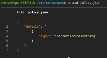 A screenshot of a command line. The command "batcat policy.json" has just been run. The output is `{ "default": [{ "type": "insecureAcceptAnything" }] }`. The prompt implies this is a debian system and the current working directory is `/etc/containers`.
