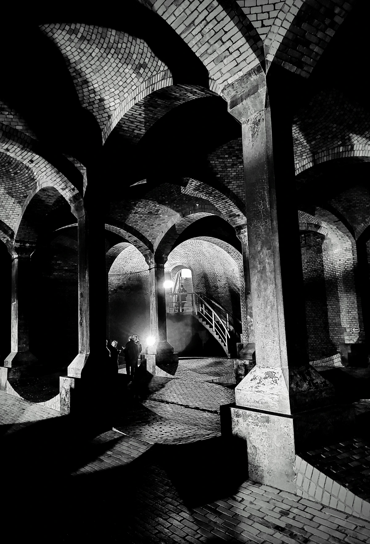 vaulted structure (water reservoir), view centered on wooden stairs leading to daylight