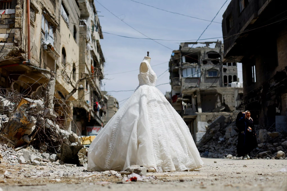 A wedding dress on display outside a shop in Gaza as brides turn to reused gowns amid shortages
