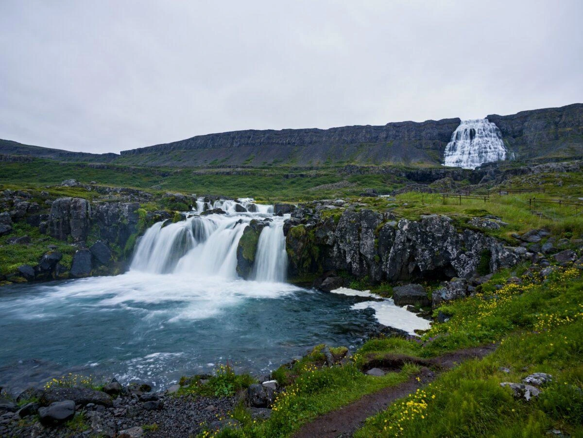 A waterfall terminates in a pool, source visible high above
