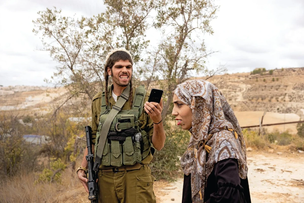 Israeli settler harasses a Palestinian woman outside of Hebron